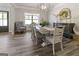 Bright dining room with a chandelier, a table with chairs and decor, a window and light colored plank flooring at 830 Turner Rd, Mcdonough, GA 30252