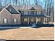Attractive two-story home with a long covered porch, perfect for enjoying the outdoors at 830 Turner Rd, Mcdonough, GA 30252