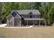 Beautiful two-story brick home featuring a welcoming front porch, shutters, and landscaped front yard at 830 Turner Rd, Mcdonough, GA 30252