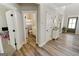 Inviting hallway featuring hardwood floors, leading to a bathroom and playroom at 830 Turner Rd, Mcdonough, GA 30252