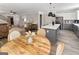 Open-concept kitchen with large island, stainless steel appliances, and wood dining table at 830 Turner Rd, Mcdonough, GA 30252