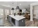 Spacious kitchen island with seating, modern appliances, flowing to a cozy living space at 830 Turner Rd, Mcdonough, GA 30252