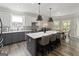 Bright kitchen featuring white cabinets, gray island with seating, stainless appliances, and tile backsplash at 830 Turner Rd, Mcdonough, GA 30252