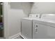 Bright laundry room featuring a stacked washer and dryer set and wire shelving for optimal storage solutions at 830 Turner Rd, Mcdonough, GA 30252