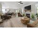 Open-concept living room with a stone fireplace, modern decor, and view of the kitchen at 830 Turner Rd, Mcdonough, GA 30252