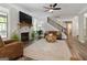 Cozy living room with fireplace, plush seating, and view of the modern staircase at 830 Turner Rd, Mcdonough, GA 30252