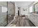 Serene main bath with glass-enclosed shower, soaking tub, dual sinks, and modern fixtures, creating a spa-like experience at 830 Turner Rd, Mcdonough, GA 30252