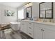 Bright main bathroom featuring a soaking tub, dual sinks, and white cabinetry, offering a luxurious and functional space at 830 Turner Rd, Mcdonough, GA 30252
