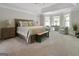 Spacious main bedroom featuring tray ceilings, a seating area with plentiful natural light, and neutral carpeting at 830 Turner Rd, Mcdonough, GA 30252