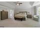 Bright main bedroom suite with tray ceilings and neutral walls, flowing seamlessly to the main bath through a connecting door at 830 Turner Rd, Mcdonough, GA 30252