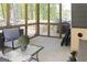 A comfortable screened porch featuring a seating area and views of the surrounding woods at 830 Turner Rd, Mcdonough, GA 30252