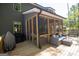 The home has a screened in porch and outdoor seating area for grilling and entertaining at 830 Turner Rd, Mcdonough, GA 30252