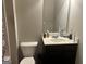 Bathroom featuring a single vanity, toilet, and a mirror, with basic fixtures and neutral wall color at 2478 Oakleaf Rdg, Lithonia, GA 30058