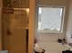 Bright bathroom with a glass-enclosed shower and soaking tub by a window at 2478 Oakleaf Rdg, Lithonia, GA 30058