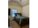 Bedroom with vaulted ceiling, a window, and a bed with a unique blue and black patterned comforter at 2478 Oakleaf Rdg, Lithonia, GA 30058