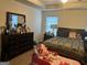 Cozy bedroom features a comfortable bed, dresser and natural light from the window at 2478 Oakleaf Rdg, Lithonia, GA 30058
