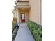 Covered front door and porch with brick accents and lush landscaping to the front sidewalk at 2478 Oakleaf Rdg, Lithonia, GA 30058