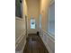 Hallway with light walls, hardwood flooring, white trim, and a front door with windows and blinds at 2478 Oakleaf Rdg, Lithonia, GA 30058