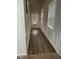 Hallway with light walls, hardwood flooring, white trim, and a front door with windows and blinds at 2478 Oakleaf Rdg, Lithonia, GA 30058