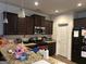 Kitchen featuring granite countertops, stainless steel appliances, and dark brown wooden cabinetry at 2478 Oakleaf Rdg, Lithonia, GA 30058