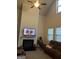 Bright living room with a fireplace, ceiling fan, vaulted ceilings, and large windows for ample natural light at 2478 Oakleaf Rdg, Lithonia, GA 30058