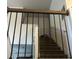 View of a carpeted staircase through metal railing, showing the upward direction with neutral wall colors at 2478 Oakleaf Rdg, Lithonia, GA 30058