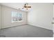 Neutral bedroom with carpet, ceiling fan, and a window for natural light at 992 Bay Pointe Sw Way, Lilburn, GA 30047