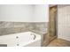 Bright bathroom featuring a soaking tub, a glass shower enclosure and tile surround at 133 Harold Dr, Mcdonough, GA 30253