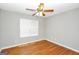 Bright bedroom with hardwood floors and a ceiling fan at 133 Harold Dr, Mcdonough, GA 30253