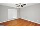 Bedroom featuring hardwood floors, a ceiling fan and large window for ample natural light at 133 Harold Dr, Mcdonough, GA 30253
