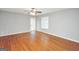 Bedroom featuring hardwood floors, a ceiling fan, a door to the backyard and a window at 133 Harold Dr, Mcdonough, GA 30253