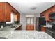 Well-equipped kitchen with granite countertops, stainless steel appliances, and dark backsplash at 133 Harold Dr, Mcdonough, GA 30253