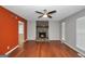 Cozy living room with hardwood floors, stone fireplace and a ceiling fan at 133 Harold Dr, Mcdonough, GA 30253