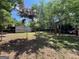 Backyard with chain link fence, shed, shade trees, and patchy ground at 360 Meadowbrook Dr, Mcdonough, GA 30253