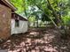 Sideyard view featuring brick exterior and window; mature trees provide shade and privacy at 360 Meadowbrook Dr, Mcdonough, GA 30253