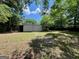 A spacious backyard featuring a storage shed and a mix of shaded and sunny areas at 360 Meadowbrook Dr, Mcdonough, GA 30253