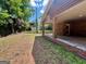 Spacious backyard with a covered patio, grassy lawn, and scattered trees at 360 Meadowbrook Dr, Mcdonough, GA 30253