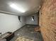 A view of the basement with a brick wall, small windows, and ample space at 360 Meadowbrook Dr, Mcdonough, GA 30253