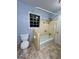 Bathroom with a toilet, shower/tub, and a window bringing in natural light at 360 Meadowbrook Dr, Mcdonough, GA 30253