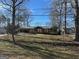 Traditional single-Gathering home with a metal roof, carport, and a spacious front lawn at 360 Meadowbrook Dr, Mcdonough, GA 30253