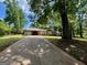 Single story home with mature trees and a long driveway leading up to the residence at 360 Meadowbrook Dr, Mcdonough, GA 30253