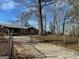 Ranch style home with metal roof, fenced yard and a long driveway at 360 Meadowbrook Dr, Mcdonough, GA 30253