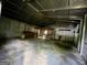 Interior of corrugated metal shed, showing tables, shelves, and concrete floor at 360 Meadowbrook Dr, Mcdonough, GA 30253