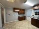 Traditional eat-in kitchen featuring wood cabinets, tile flooring, and a view to a doorway at 360 Meadowbrook Dr, Mcdonough, GA 30253