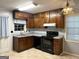Traditional kitchen with wood cabinets, stainless steel appliances, and a window over the sink at 360 Meadowbrook Dr, Mcdonough, GA 30253