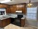 The kitchen features wooden cabinets, laminate countertops, and black appliances at 360 Meadowbrook Dr, Mcdonough, GA 30253