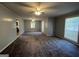 Spacious living room featuring neutral walls, plush carpeting, and natural light from multiple windows at 360 Meadowbrook Dr, Mcdonough, GA 30253