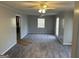 Large living room with neutral grey walls, plush grey carpet and natural light at 360 Meadowbrook Dr, Mcdonough, GA 30253
