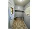 Mud room with tile floors, storage shelves, a window, and a door to the exterior at 360 Meadowbrook Dr, Mcdonough, GA 30253