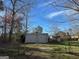 Metal building with a large open doorway in the back yard at 360 Meadowbrook Dr, Mcdonough, GA 30253